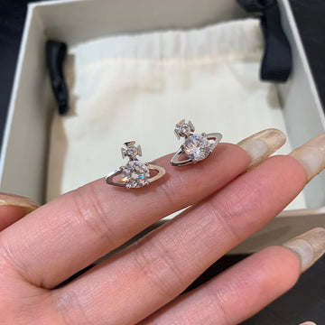 The new Queen Mother Reyna Saturn Stud Earrings are classic shiny solitaire star sparkle minimalist commuter style earrings
