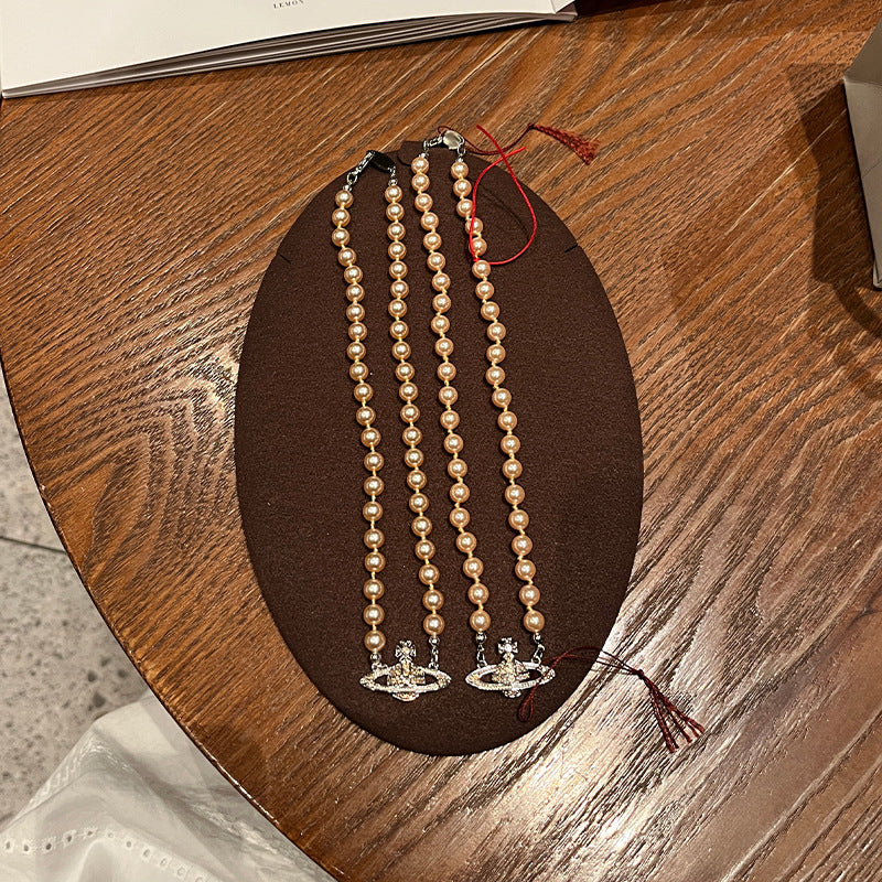 New Queen Mother West Champagne Gold Saturn Pearl Necklace Bracelet Champagne Pink Beads NANA with the same high-quality jewelry