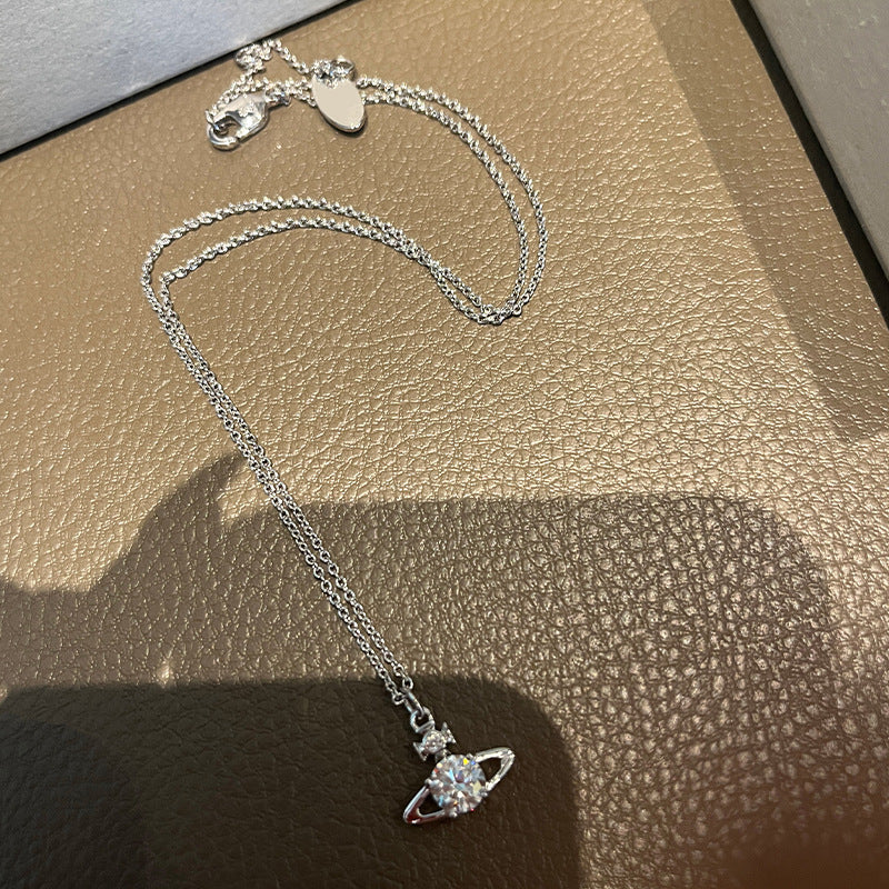 The new Reyna necklace classic shiny single diamond small Saturn planet pendant burst sparkle minimalist commuter style choker