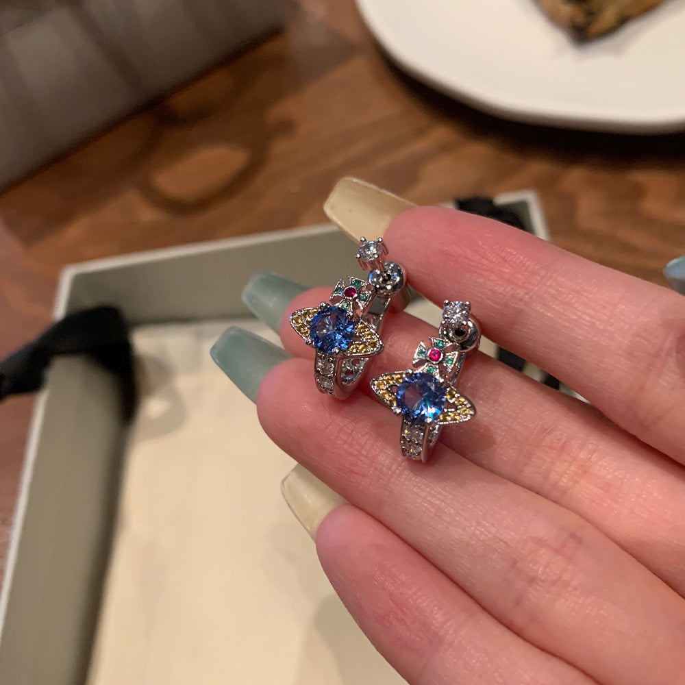 Queen Mother of the West limited color diamond opening Saturn stud earrings set with blue diamond U-shaped half rings, a two-wear earring