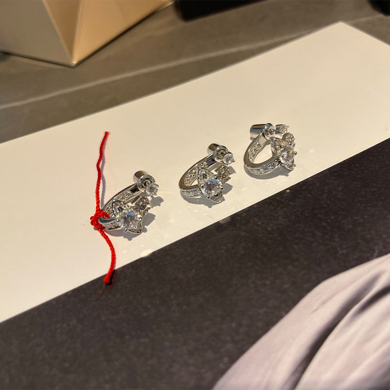 The Queen Mother of the West is full of diamond-opening Saturn stud earrings and half-hoop earrings