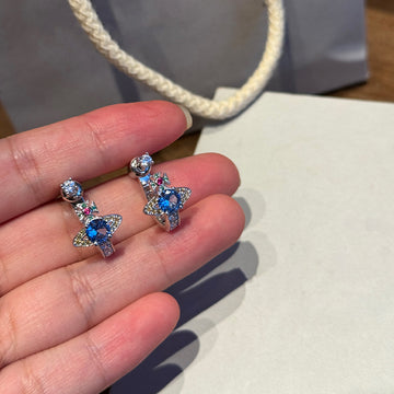 Queen Mother of the West limited color diamond opening Saturn stud earrings set with blue diamond U-shaped half rings, a two-wear earring